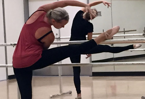 woman stretching at barre